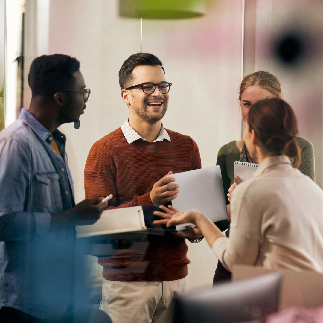 A group of smiling people in an office.